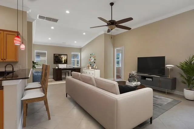 Living room featuring crown molding and recessed lighting