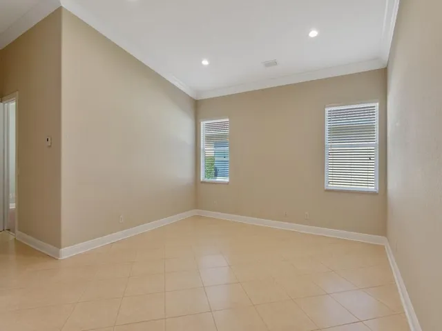 Spare room featuring crown molding and recessed lighting