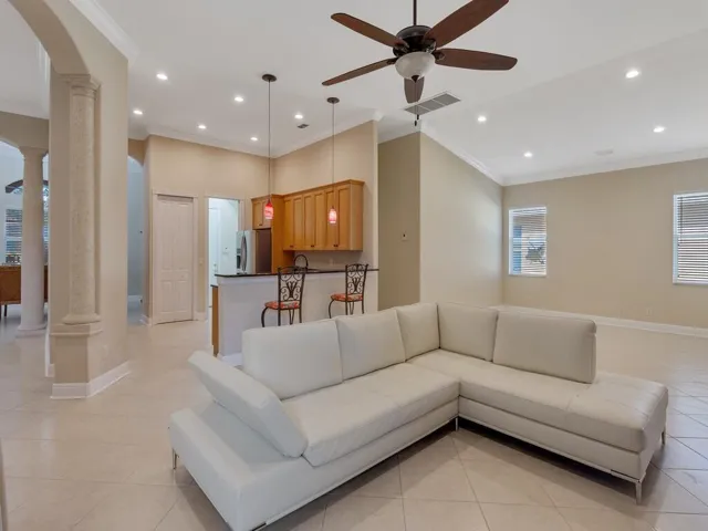 Living room featuring crown molding and recessed lighting