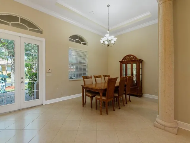 Dining Room featuring decorative columns, ornamental molding, recessed lighting, and a chandelier