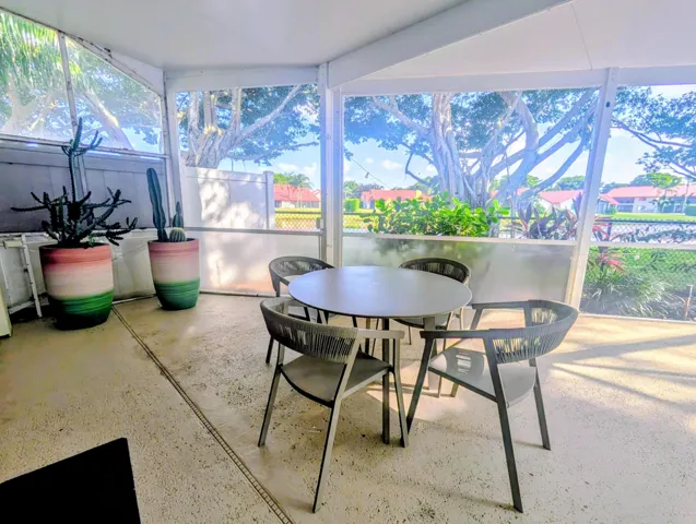Screened-in patio with light-toned concrete flooring