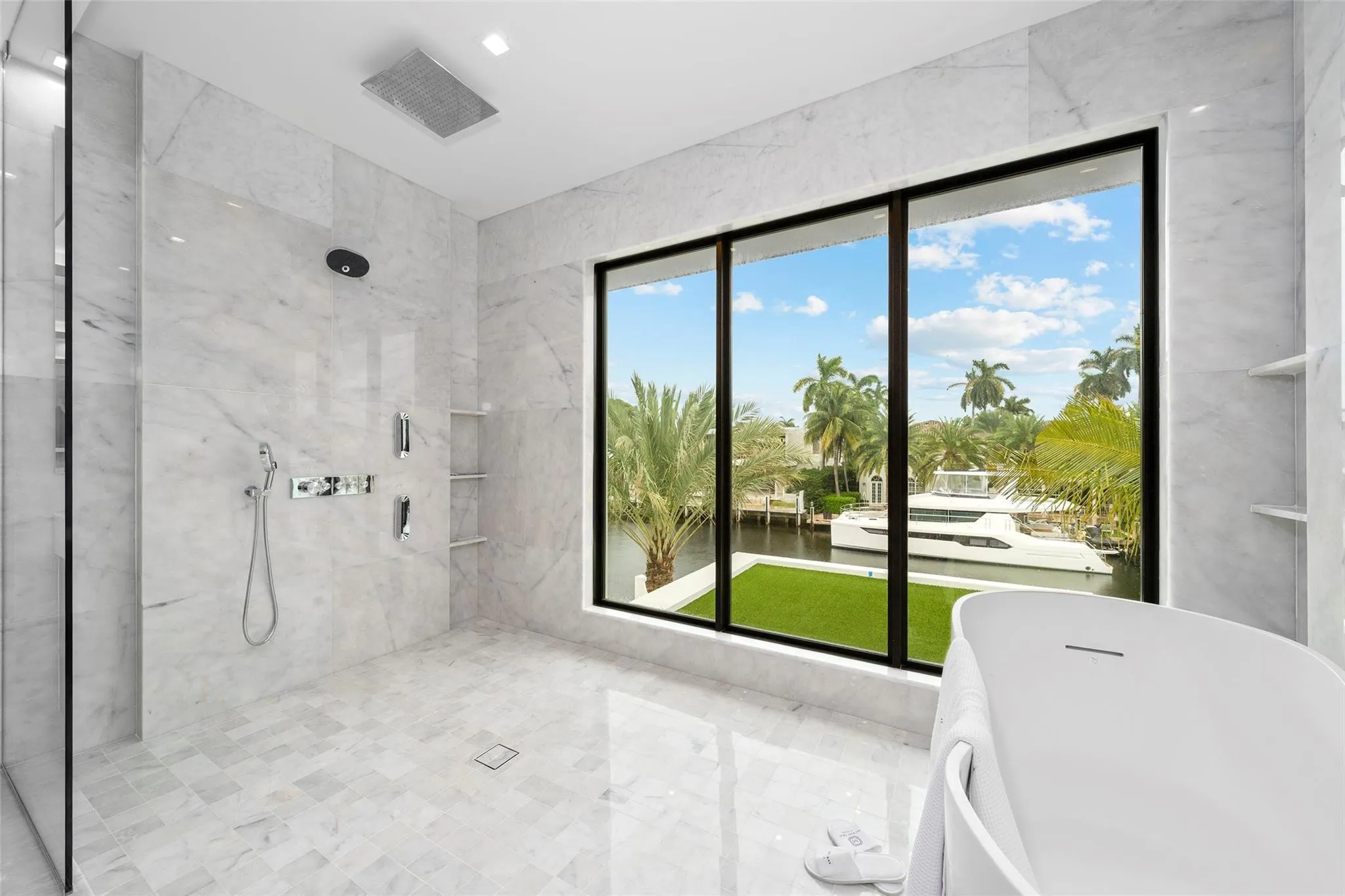 Spa-Inspired Primary Bathroom with a Luxury Bathtub and Dramatic Ceiling-Mounted Tub Filler