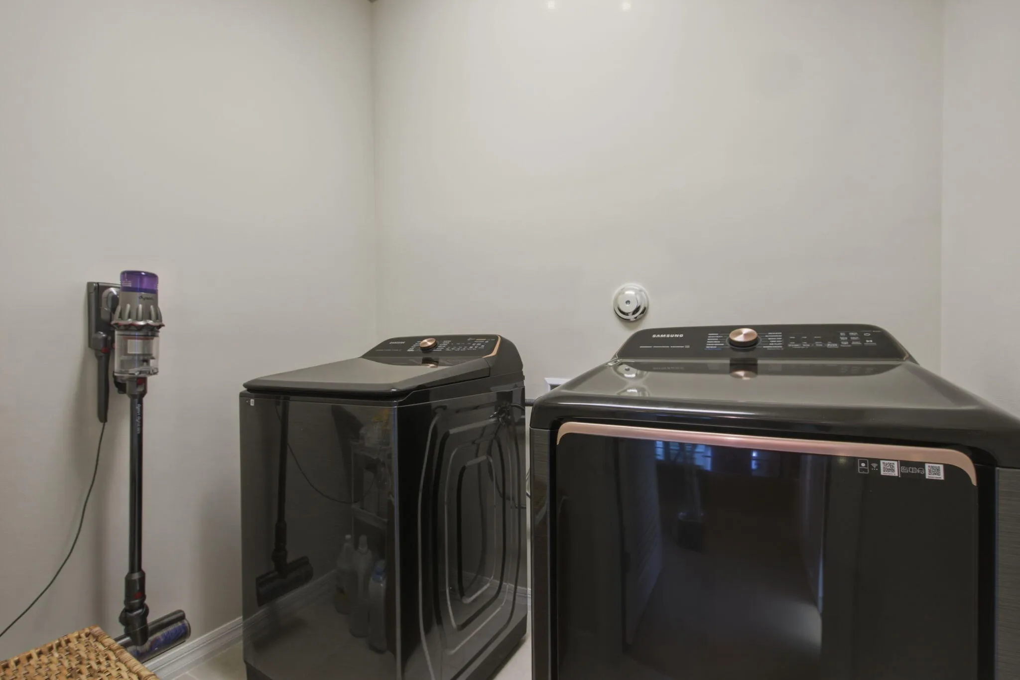 Laundry area featuring light-colored walls and a wall-mounted smoke detector
