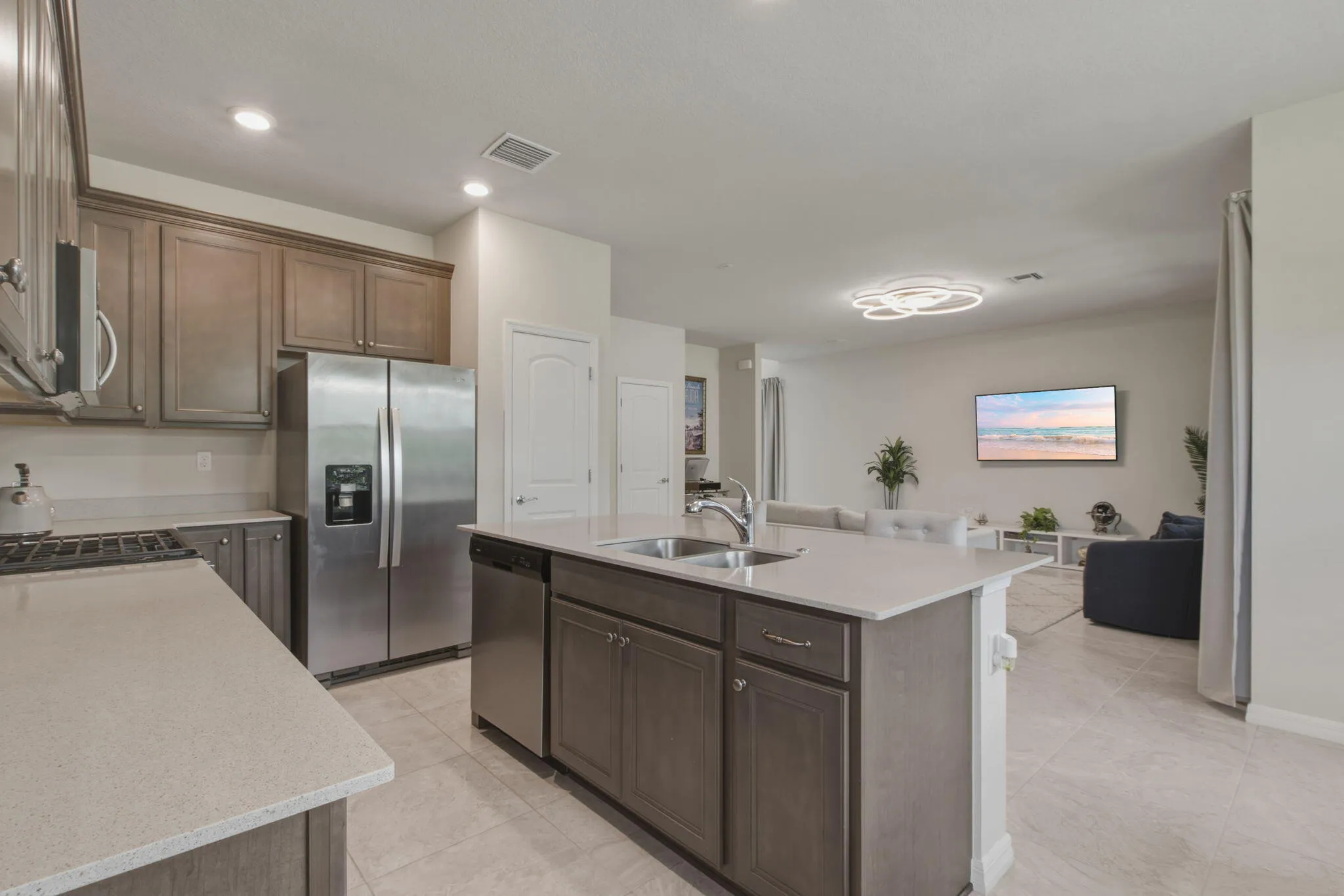 Kitchen with a central island featuring a stainless steel sink and a stainless steel dishwasher