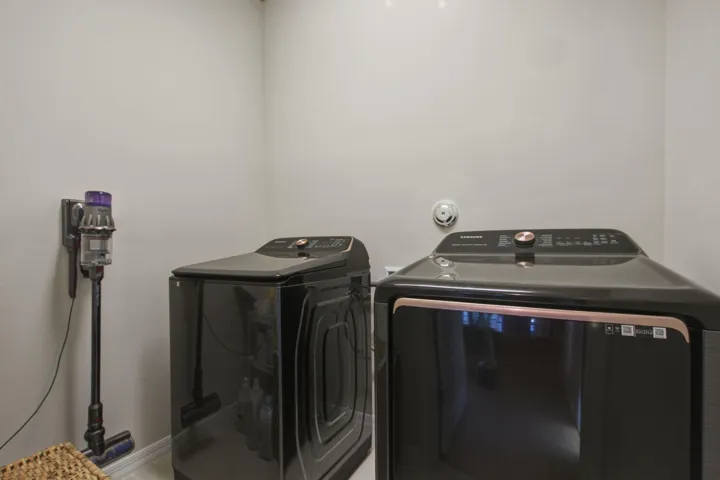 Laundry area featuring light-colored walls and a wall-mounted smoke detector