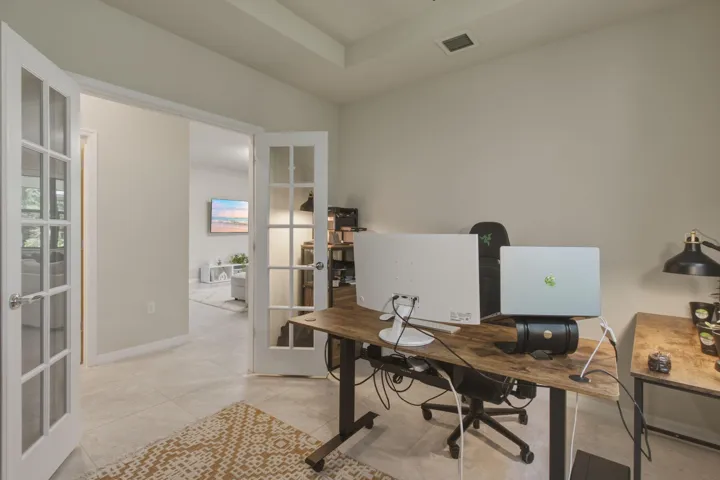 Room with light-toned wall paint and tray ceiling