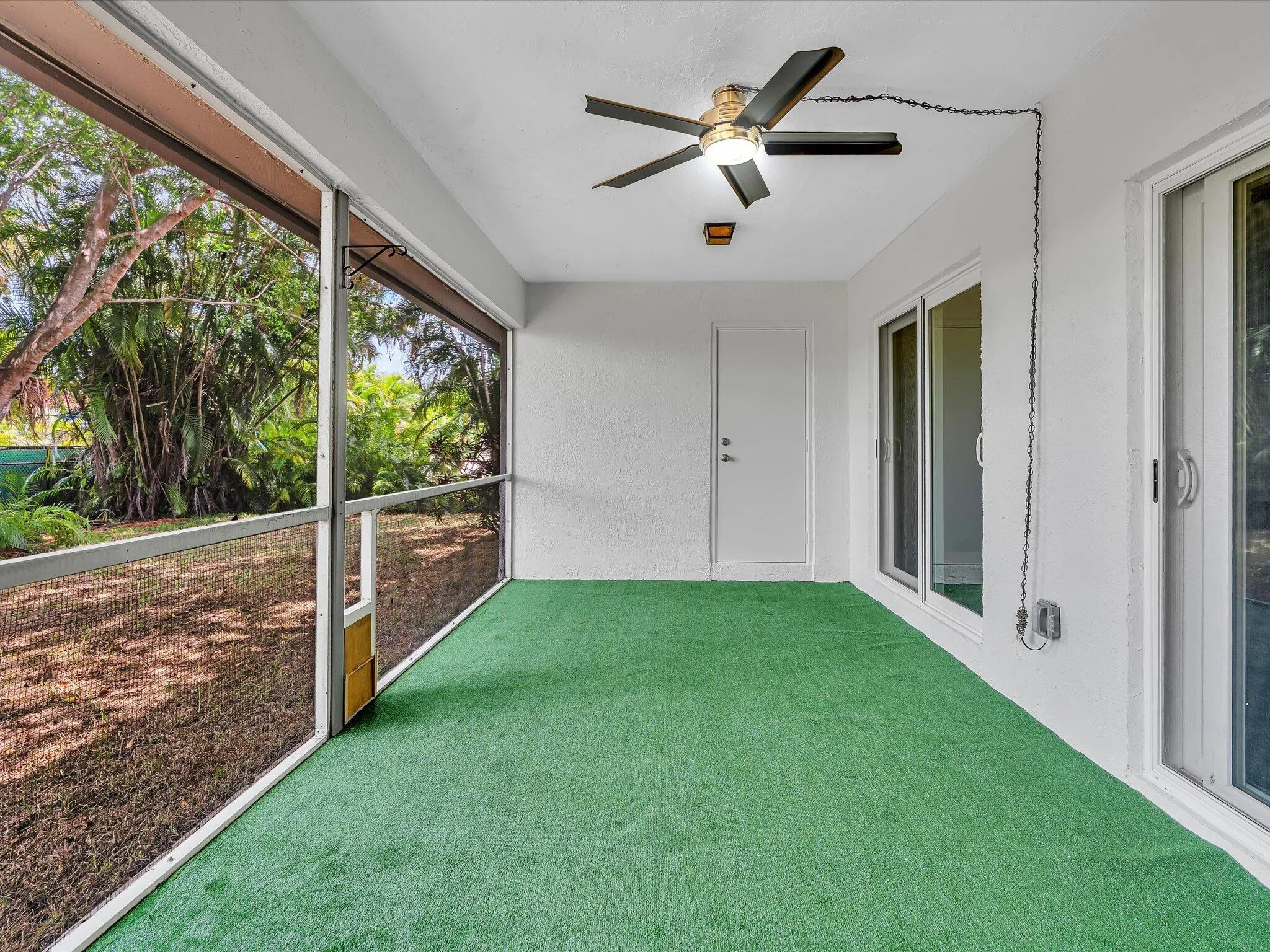 Screened patio with green artificial turf flooring