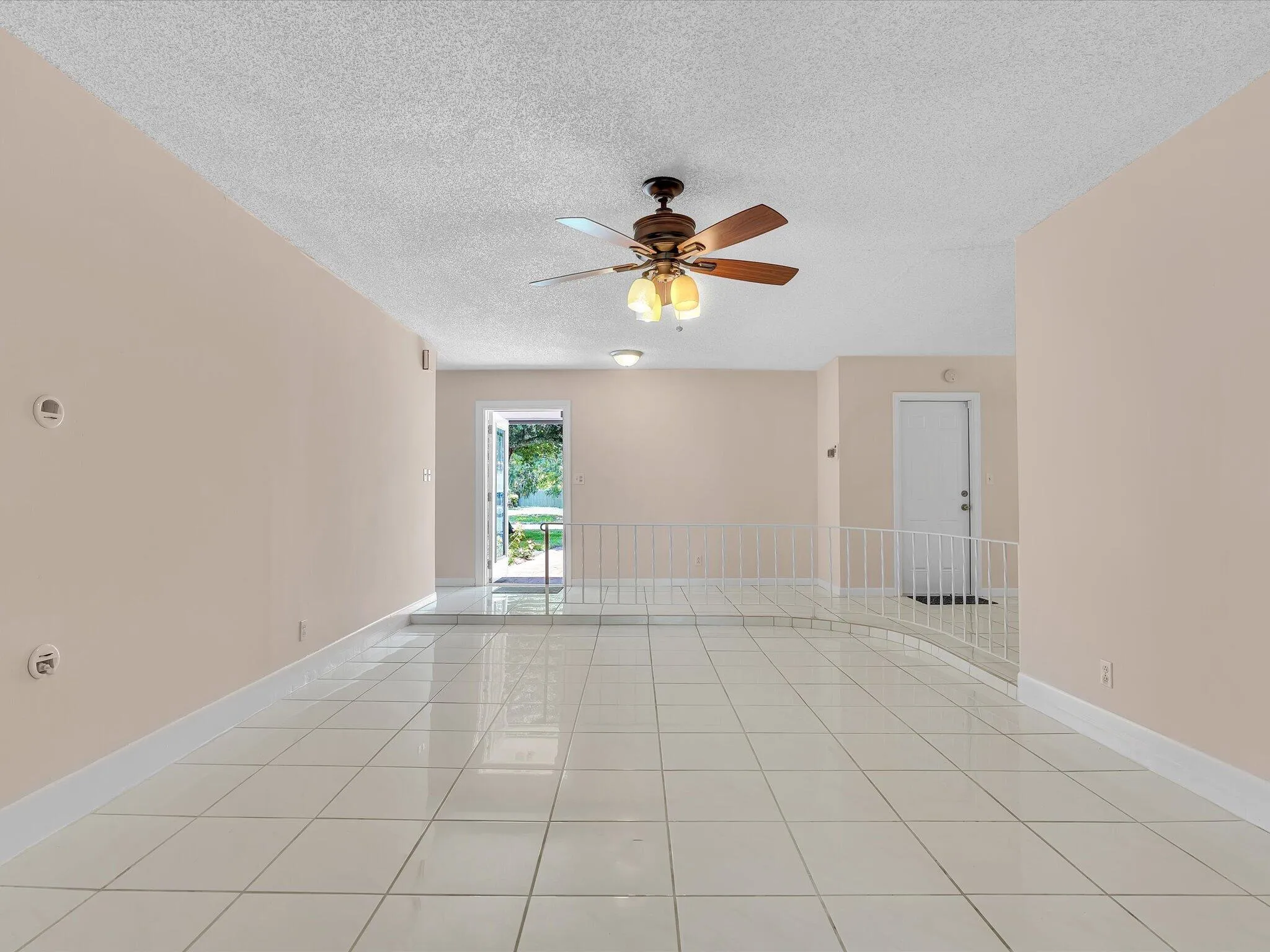 Spacious interior featuring large format tile flooring and light-toned walls