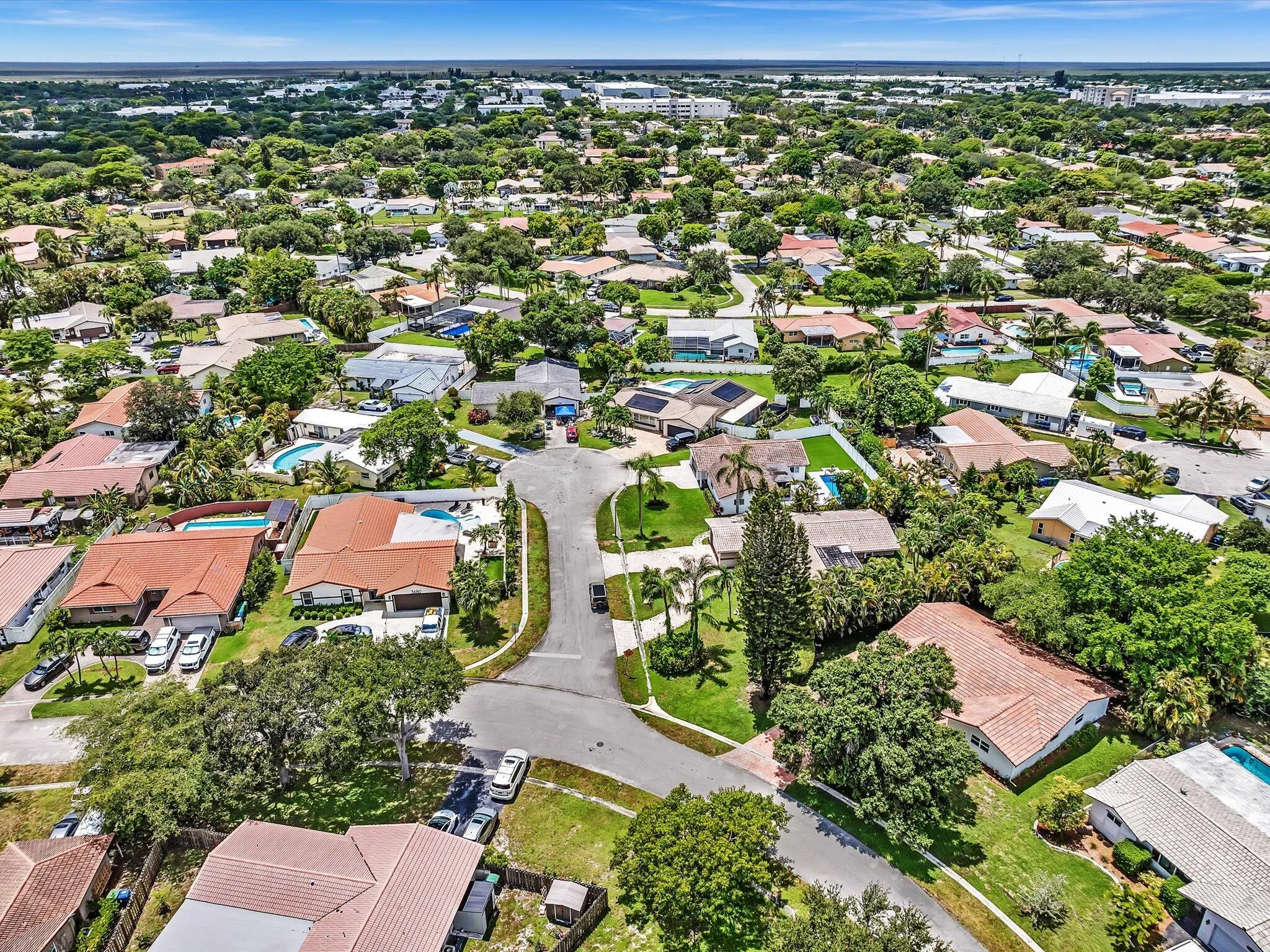 Aerial perspective showcasing a residential area with varied home styles and mature landscaping