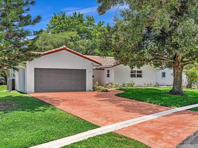 White stucco exterior with a terracotta tile roof