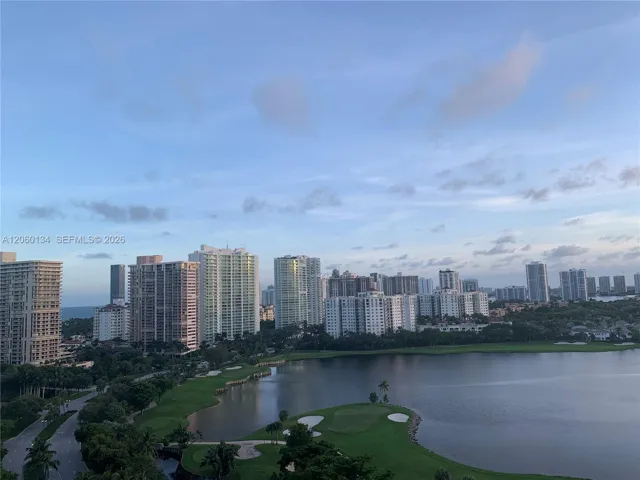 Panoramic skyline backdrop featuring a golf course, expansive lake, and lush vegetation