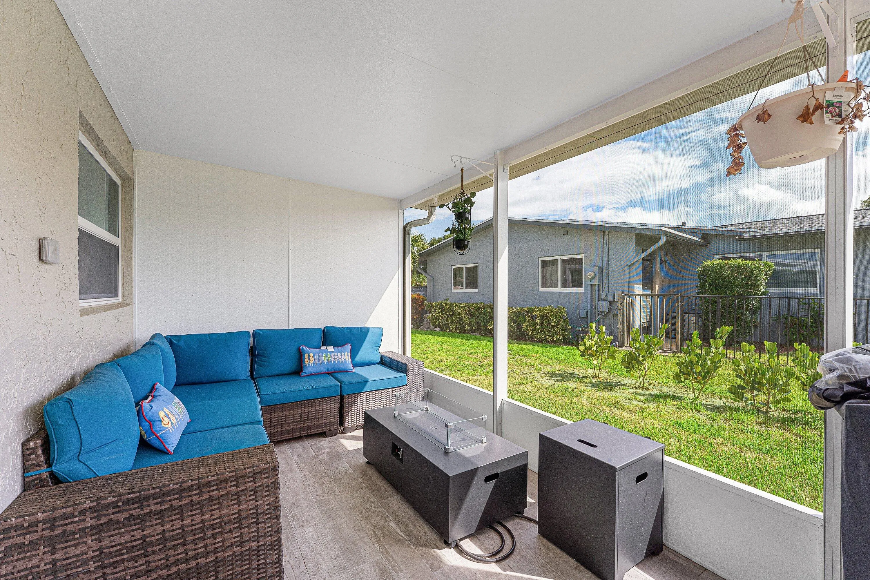 Screened patio featuring wood-finish flooring, a white ceiling, and textured exterior walls