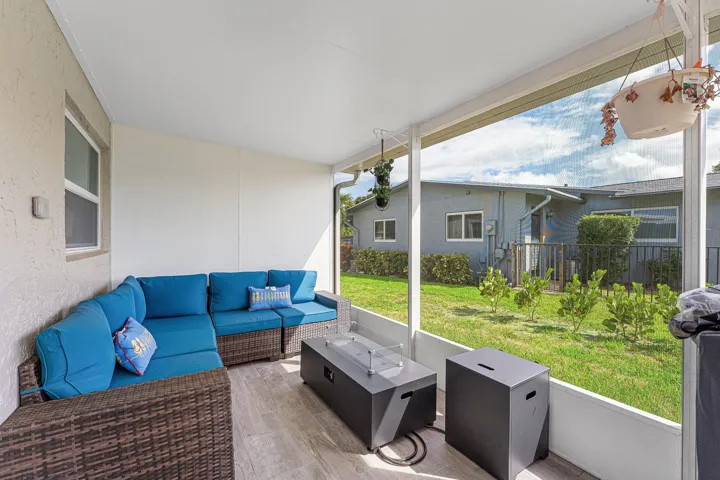 Screened patio featuring wood-finish flooring, a white ceiling, and textured exterior walls