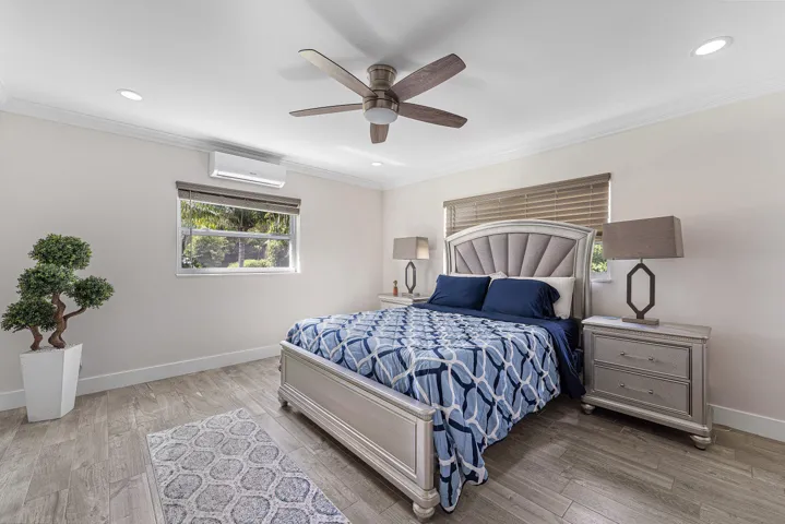 Bedroom featuring wood-finish flooring, recessed lighting, and crown molding