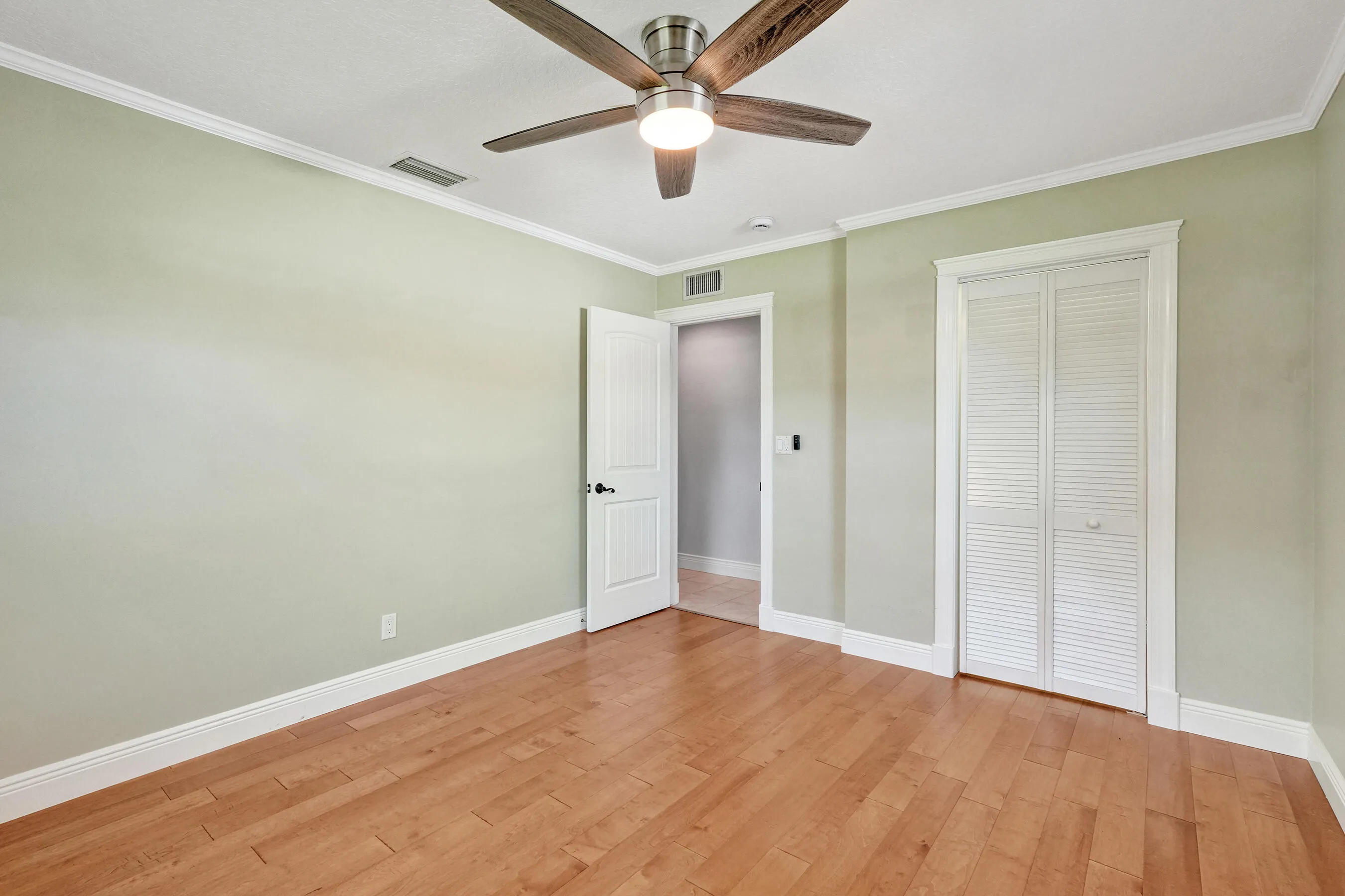 Corner bedroom features a walk-in closet. Solid core designer interior doors were installed in 2013.