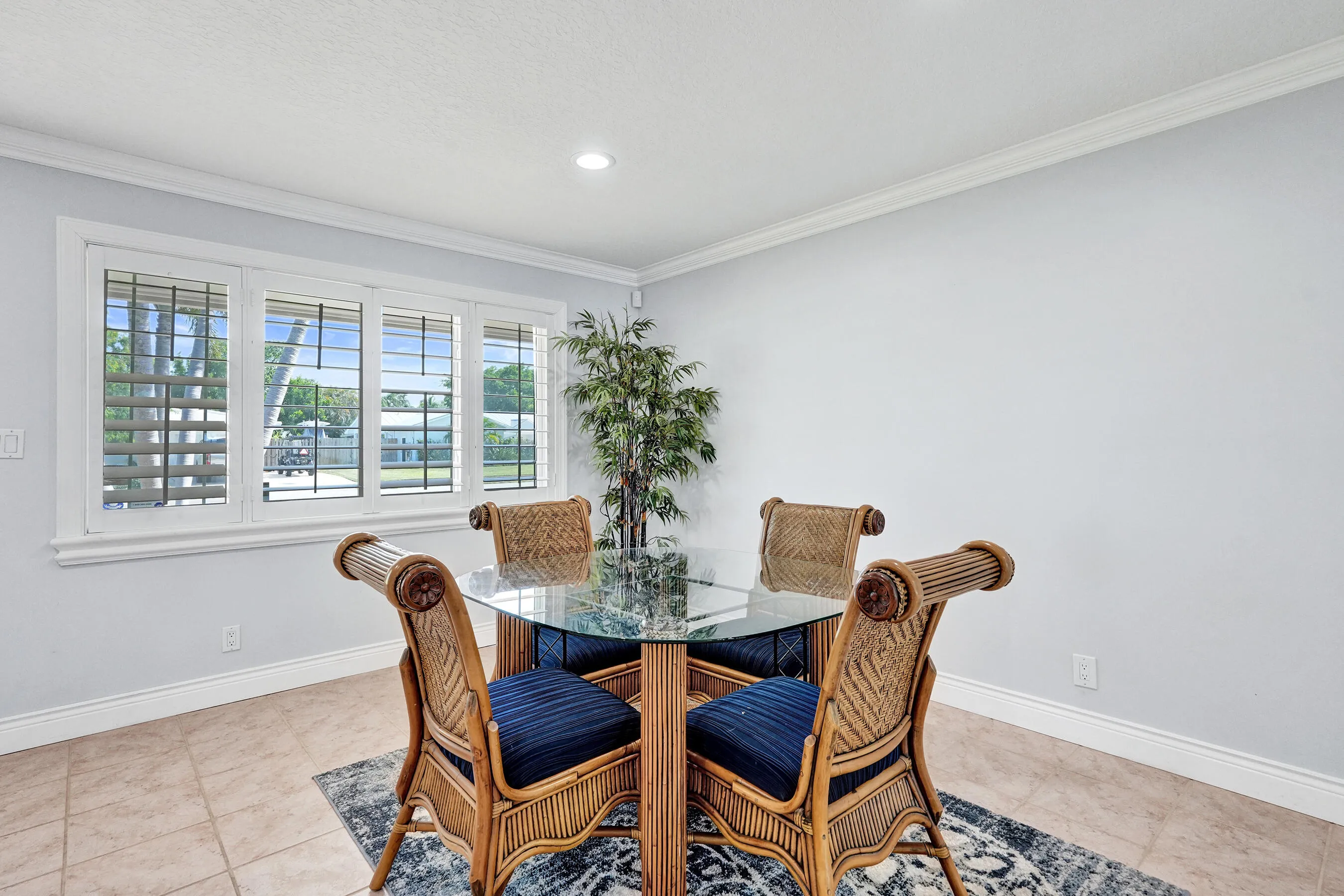 Four-panel window with plantation shutters. Dining table is here, but could easily be in the Family room.