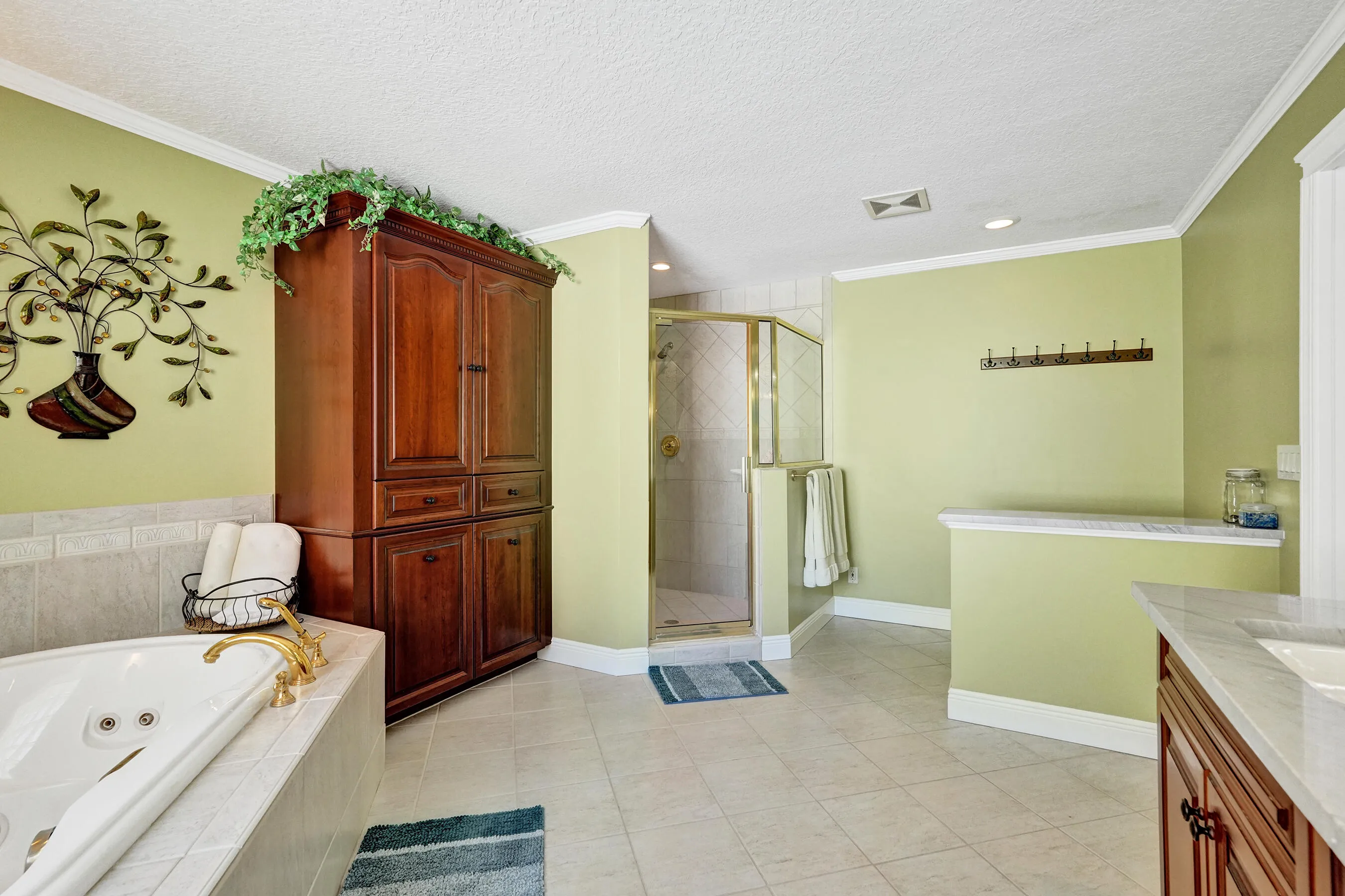 Spacious bathroom with built in cherry armoire, 2 person jacuzzi and separate shower.