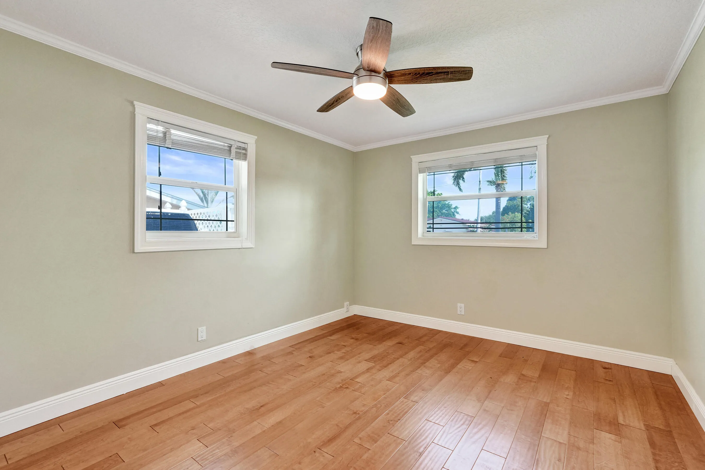 Corner bedroom with wood flooring. This room measures 10'9 x 13.