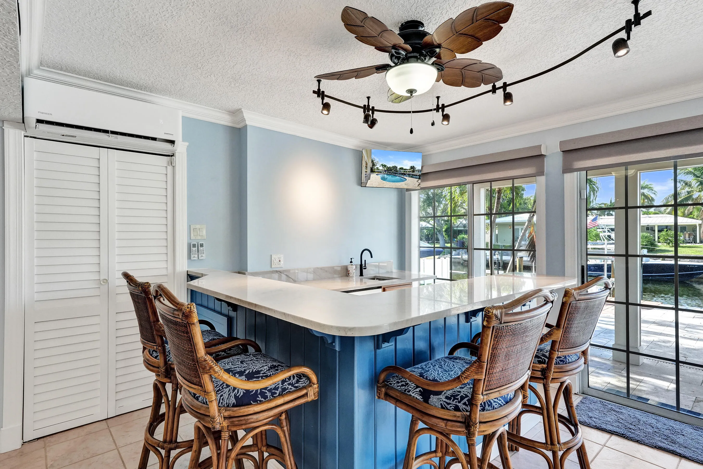 Custom built wet bar with beverage fridge and quartzite countertop.