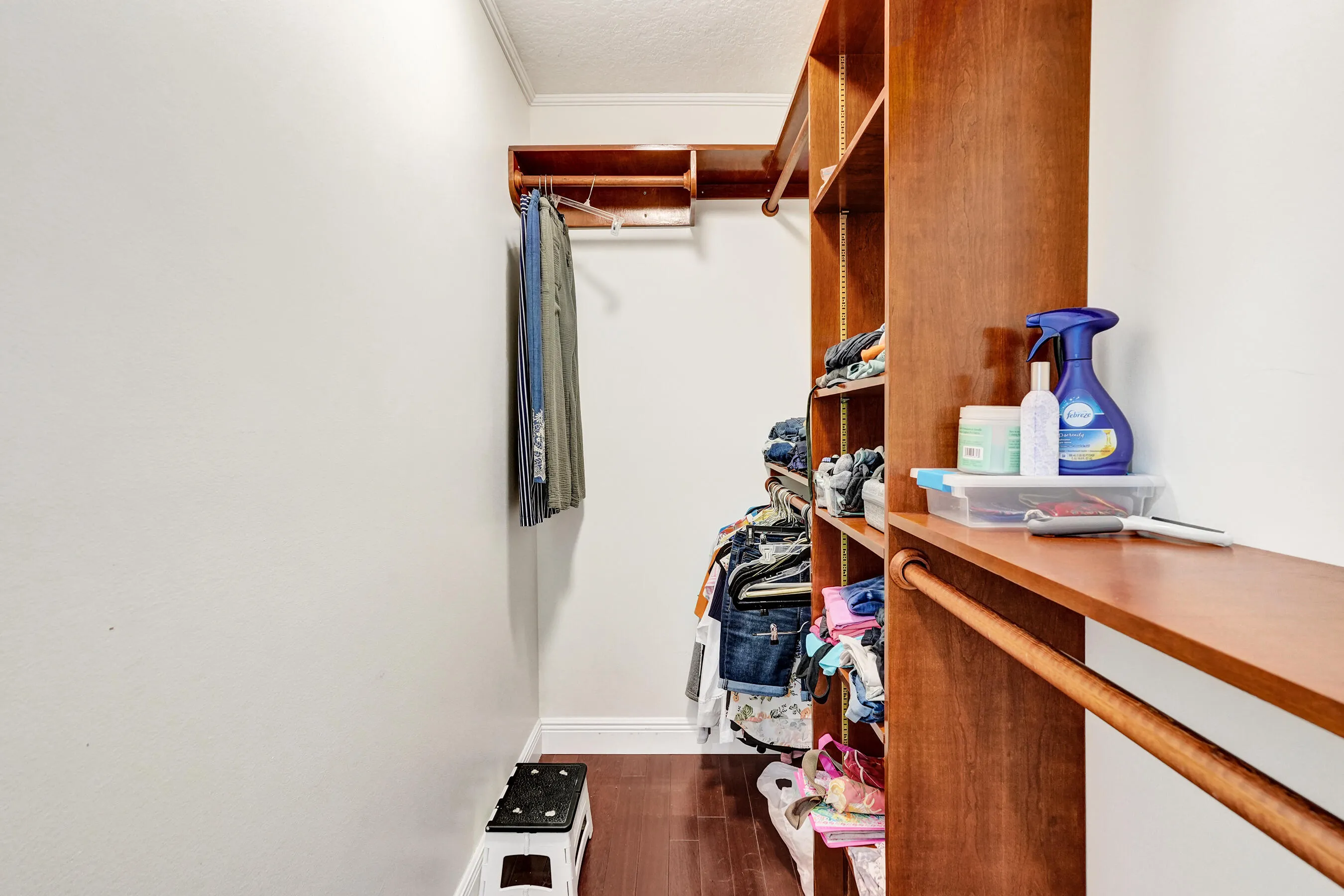 Built-in wood shelving system featuring multiple storage compartments and hanging rods
