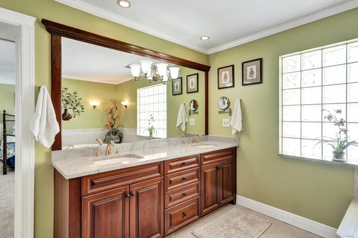 Double vanity with cherry cabinetry.