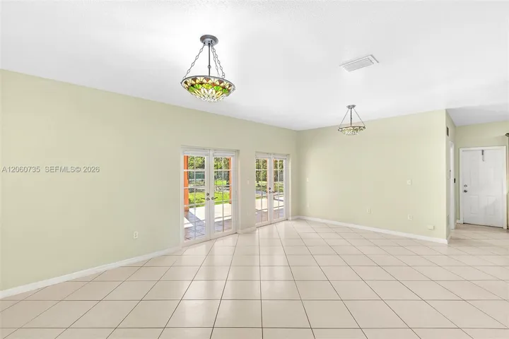 This family room is perfect for entertaining, it opens to an expansive covered terrace and backyard.