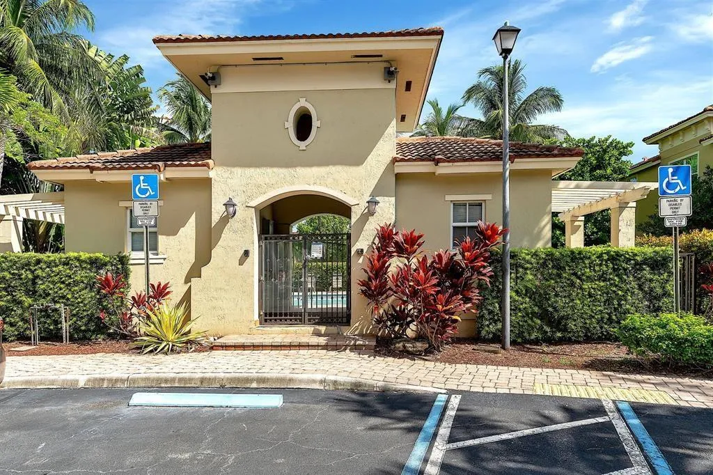 Entryway structure featuring a tiled roof and stucco exterior