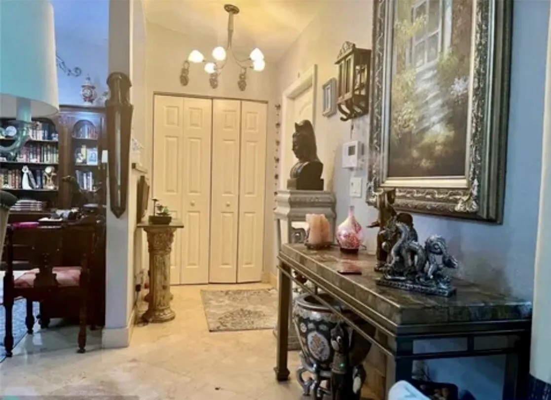 Foyer featuring a decorative console table, recessed lighting, and a prominent chandelier