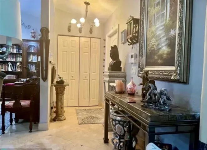 Foyer featuring a decorative console table, recessed lighting, and a prominent chandelier