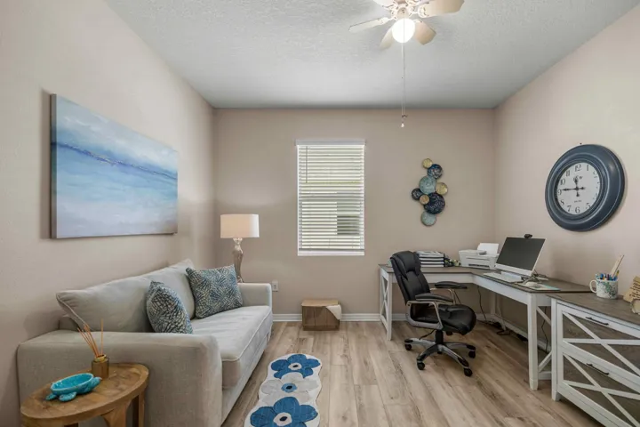 Versatile room featuring light-toned walls and wood-finish flooring