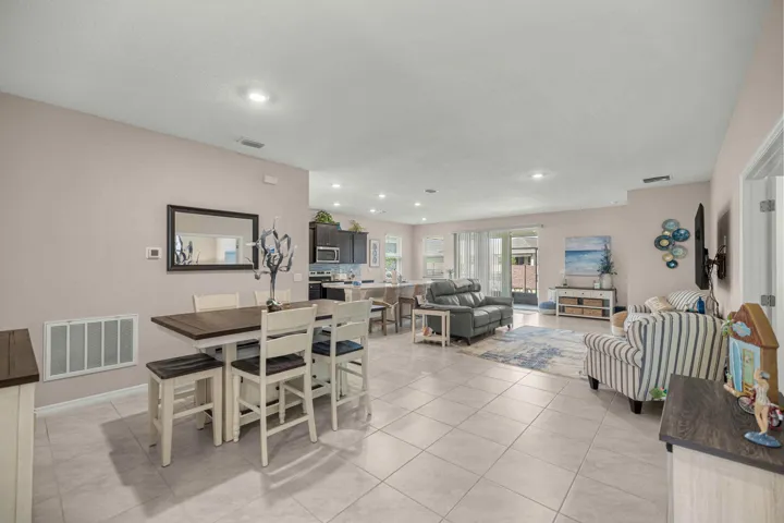 Open-concept interior featuring light tile flooring and neutral wall tones
