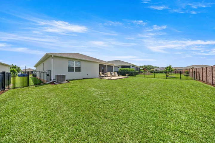 Expansive green lawn with a concrete patio area