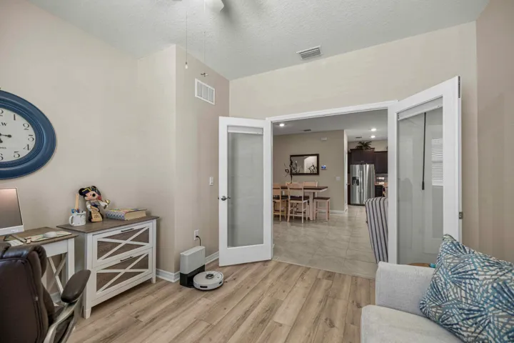 Versatile room featuring light-toned walls and wood-finish flooring
