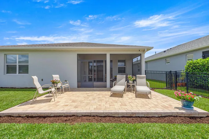 Expansive green lawn with a concrete patio area