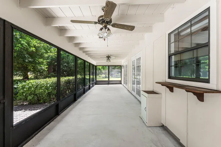 Large Screen Porch with room for Lounging and Al Fresco dining with Kitchen pass through.