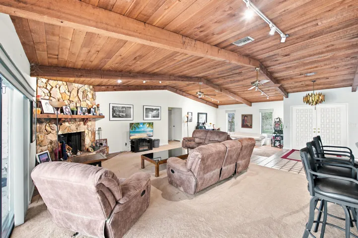 Vaulted wood-finish ceilings with exposed beams and track lighting