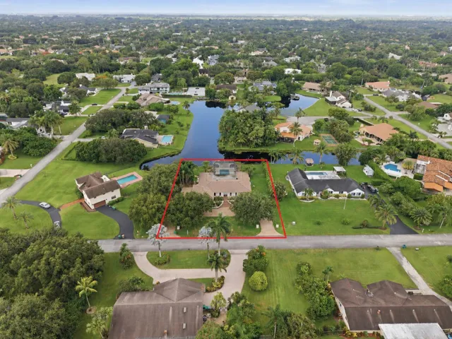 Aerial perspective showcasing a property with a prominent water frontage