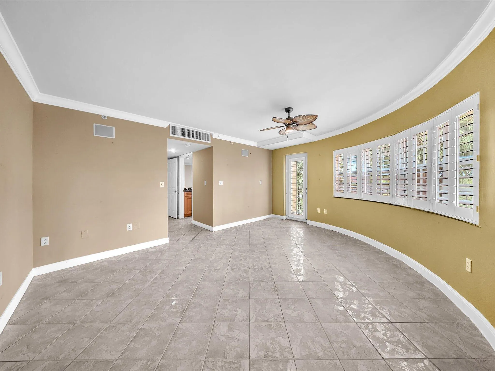 Bedroom with fans and plenty of windows for natural light