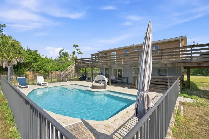 Backyard Oasis showcasing the pool, covered patio and second floor wrap around porch.