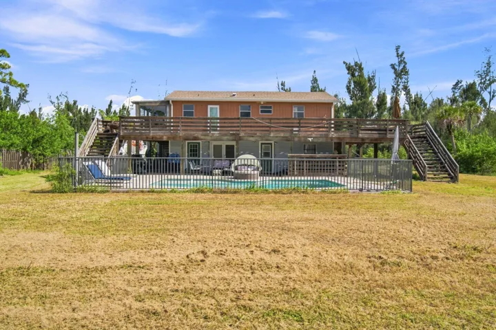 Backyard Oasis showcasing the pool, covered patio and second floor wrap around porch.