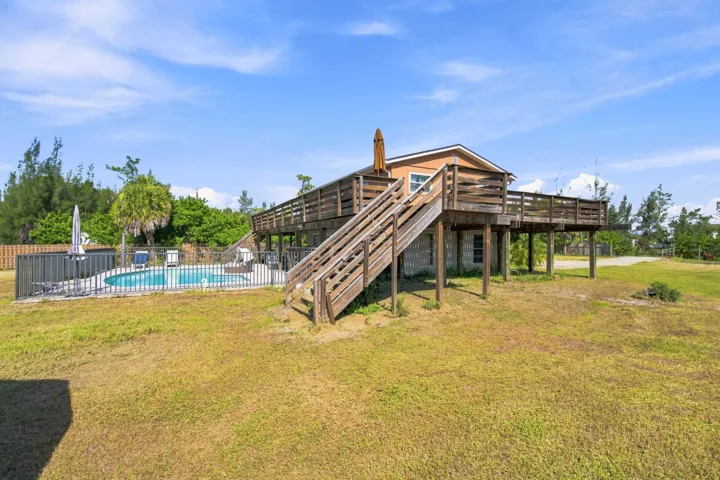 Backyard Oasis showcasing the pool, covered patio and second floor wrap around porch.