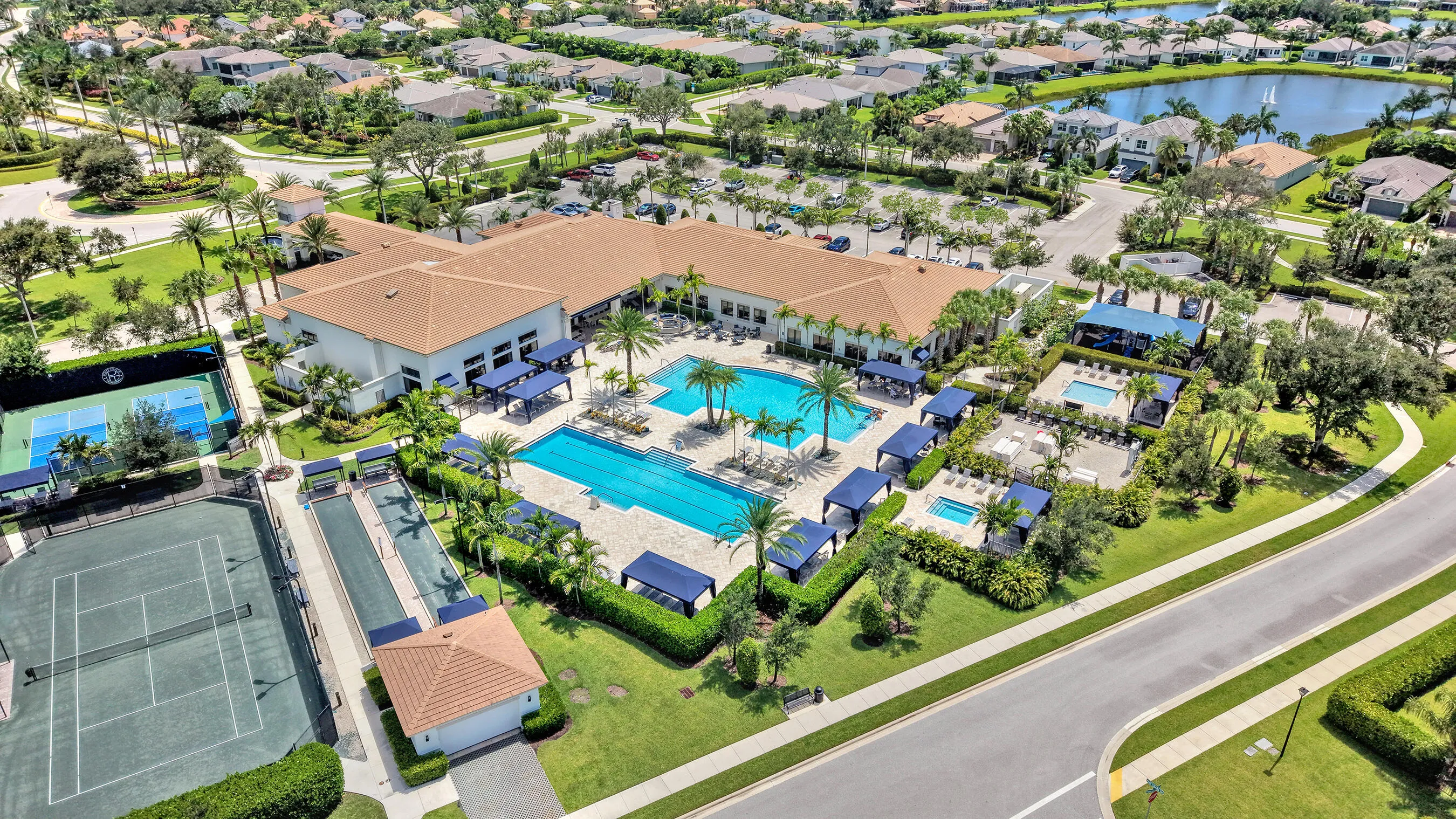 Aerial of the Polo Trace clubhouse with resort pool, spa, cabanas, sport courts, and fitness amenities.