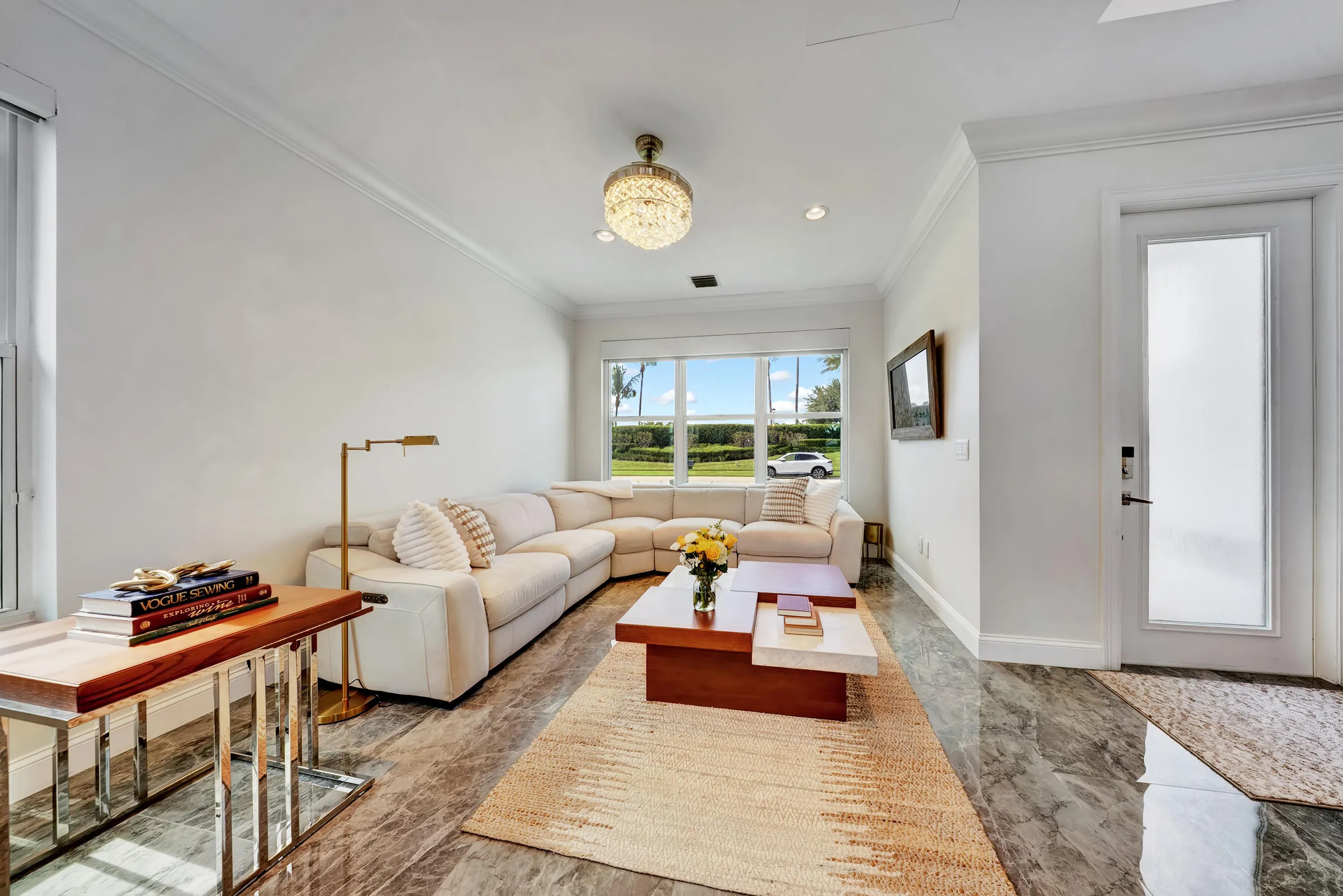 Sunlit living room with neutral designer finishes and large picture window.