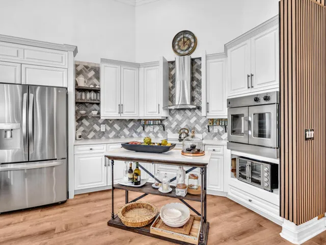 BEAUTIFUL AND FUNCTIONAL KITCHEN WITH CENTER ISLAND AND SHOWING THE FRENCH DOUBLE DOOR CONVECTION OVEN