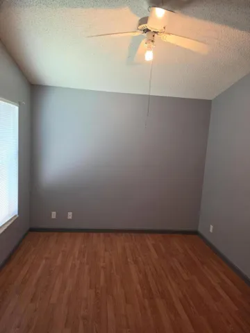 Wood-finish flooring complemented by a contrasting accent wall