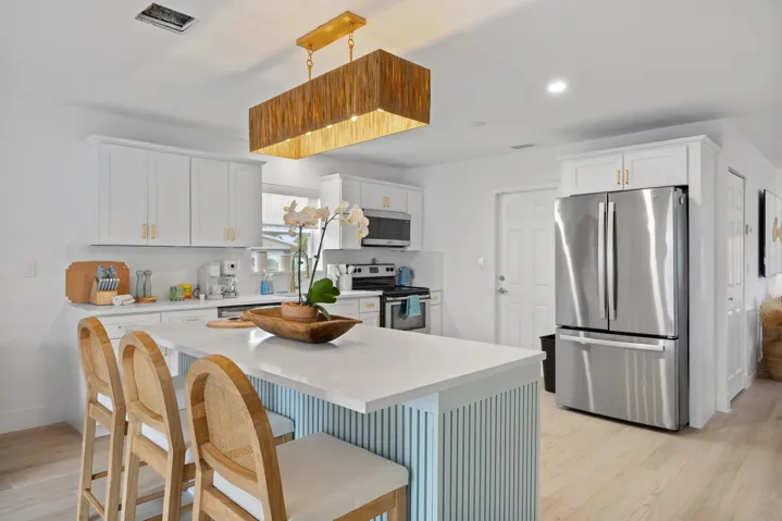 Island with barstools. Full kitchen with all appliances, coffee machines and more.