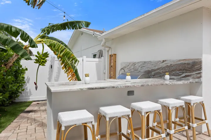 Grill, sink, refrigerator, bar top, outdoor shower.