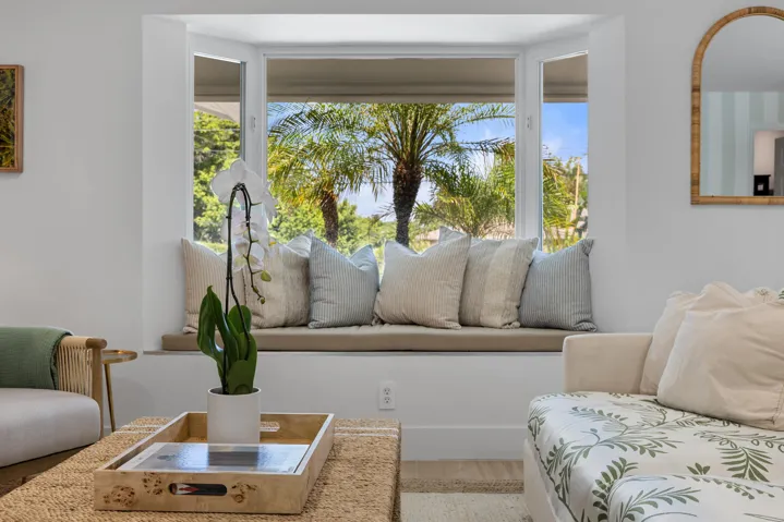 Couch, chairs, reading nook. Large smart TV.