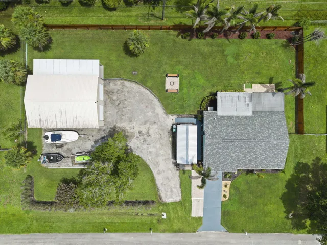 Impressive spread of a renovated home, detached workshop, landscaped yard, wood privacy fencing, and chain link fencing for pets.