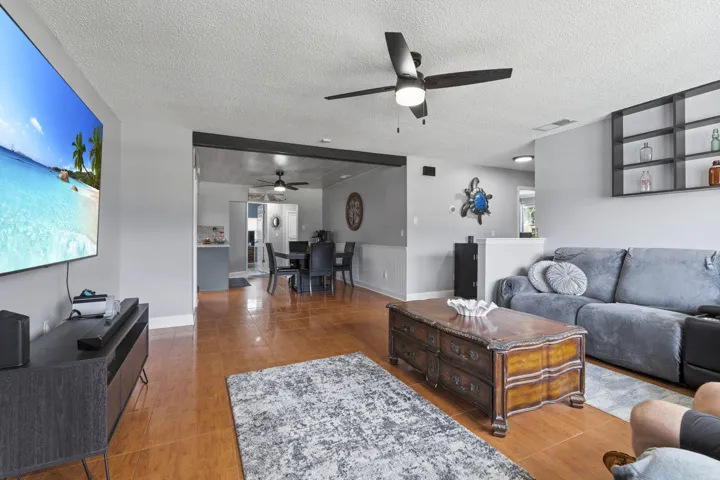 Spacious living area leading to the dining area and kitchen.
